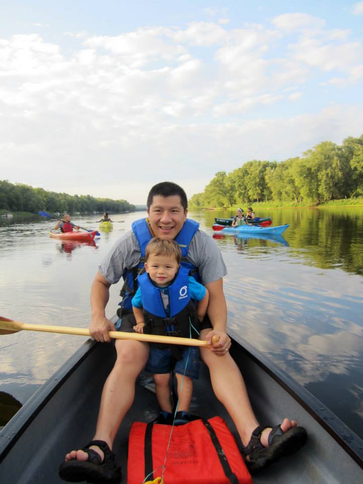 man and boy in canoe